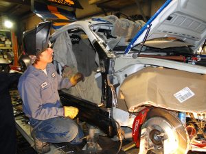 Mike George repairing crash damage to a Porsche Cayman